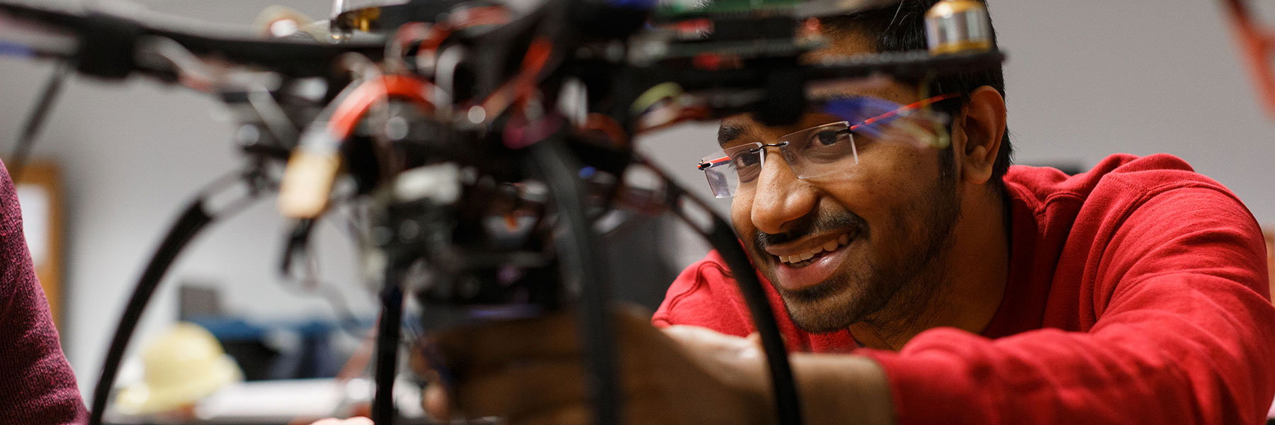 An IUPUI engineering student working on a drone.